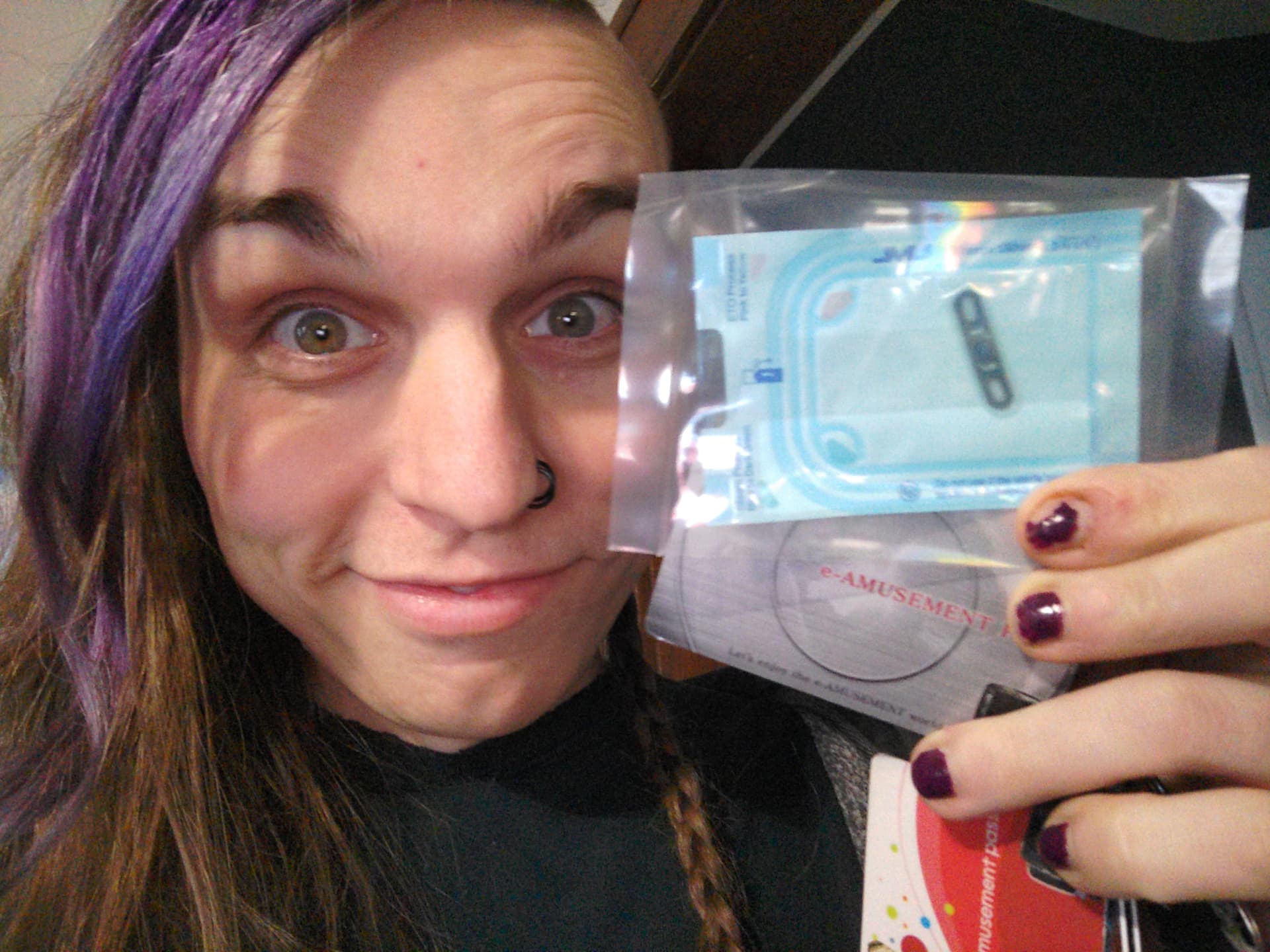 Vvn smiling and holding a packaged impland and an e-amusement card