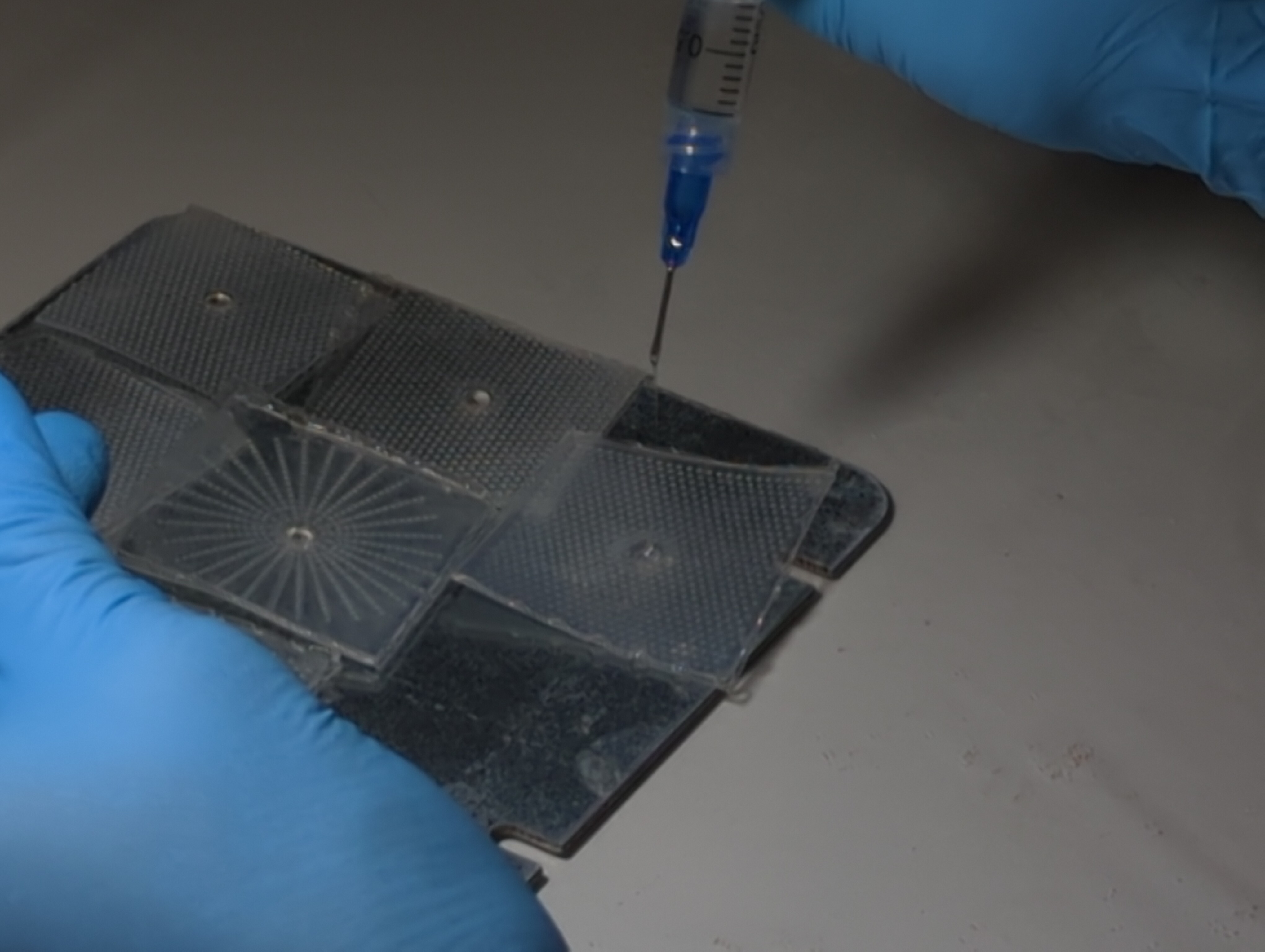 A needle dripping epoxy into a mold